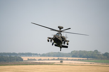 close-up front view of a British army Boeing Apache Attack helicopter gunship AH64E AH-64E ArmyAirCorp in low level flight