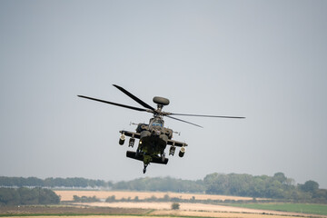 close-up front view of a British army Boeing Apache Attack helicopter gunship AH64E AH-64E ArmyAirCorp in low level banking flight © Martin