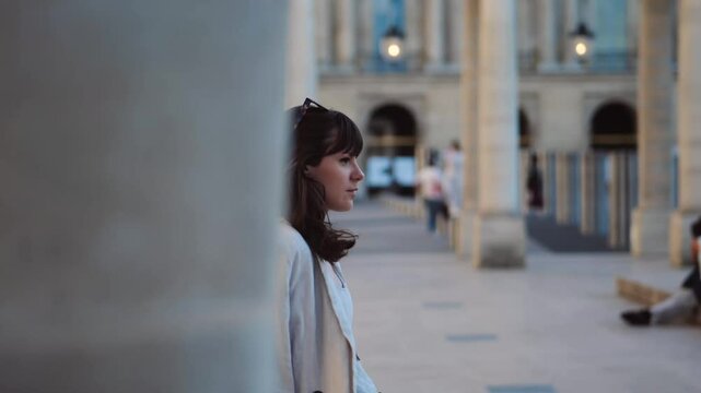 Beautiful woman with sun glasses walking, profil view, on bright summer day in paris