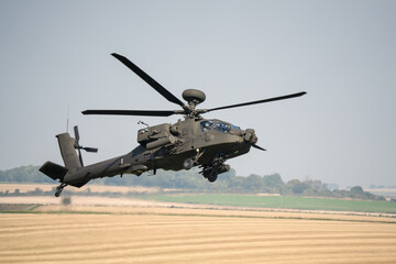 close-up side profile of British army Boeing Apache Longbow Attack helicopter gunship ZM733 AH64E AH-64E ArmyAirCorp in low level banking flight