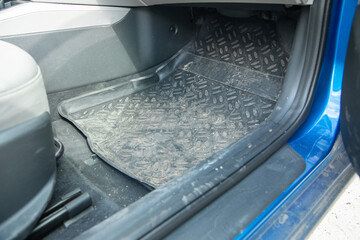 Dirty car floor mat in auto.