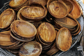 Many wooden handmade bowls or plates in the street market in Europe. Original souvenirs from the trip. Travel gift. Unique wood grains by an artisan. Crafts for sale.