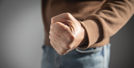 Angry caucasian man threatening with his fist.