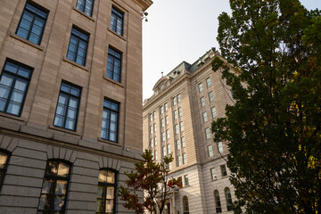 Low angle view of historic Beaux-arts buildings seen during a sunny fall morning in the Parliament area of Quebec City, Quebec, Canada