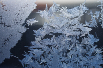Beautiful frost designs intricately adorn a window, showcasing the exquisite artistry of nature...