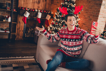 Photo of handsome good mood guy wear print sweater celebrating noel xmas video call modern device indoors room home house