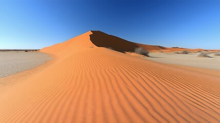 Sand dunes in the desert, blue sky, tall ridge wind blown dune landscape.