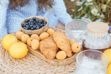 Picnic in the chamomile field. A large field of flowering daisies. The concept of outdoor recreation.