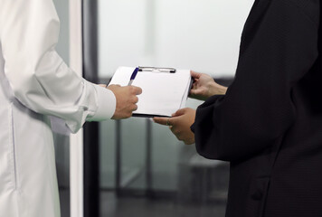 Arab man sign documents with an arab women in the office
