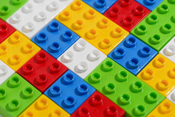 Angled view solid background with colored plastic blocks or bricks toy for building constructions. The concept of children's educational games. Image for your design