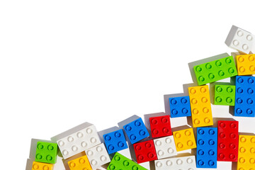 Top view of many colorful plastic blocks bricks toy for building constructions on blank png isolated background in corner. The concept of children's educational games. Place for your text and design