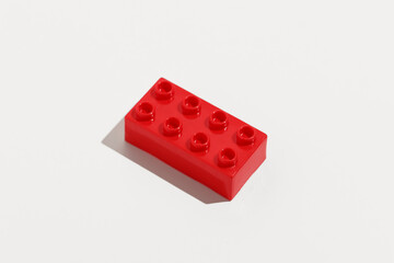 Top view red rectangular plastic block brick toy for building constructions on white isolated...
