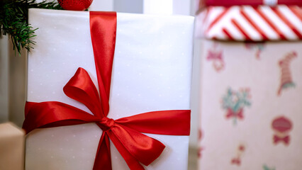 Neatly wrapped gift boxes beneath the contemporary Christmas tree in home, Xmas