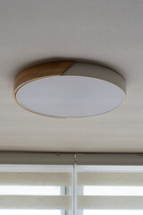 a circular ceiling lamp in an apartment