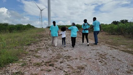 family in the community with wind generators turbines, Wind turbines are alternative electricity sources, the concept of sustainable resources and Renewable energy - Powered by Adobe