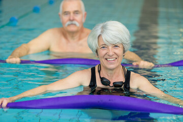 middle aged happy couple in swimming pool