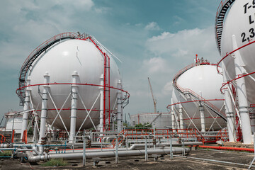 White spherical propane tanks containing fuel gas