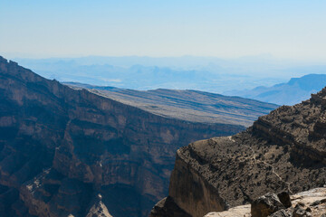 Fototapeta premium Exploring the rugged beauty of Oman’s mountain ranges under a clear blue sky in the early morning light
