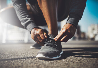 Hands, runner or tie shoes in street for cardio training, running exercise and fitness workout in...