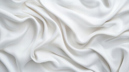 Obraz premium A delicate, white fabric drapes elegantly, showcasing soft textures and gentle folds, ideal for various fashion or interior design applications.