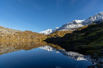 Obraz premium Beautiful mountain reflections in the lake surface in Northern Norway autumn. Seasonal scenery of Scandinavia.