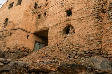 Exploring the ancient stone architecture of a village in Oman&rsquo;s rugged landscape during the late afternoon glow