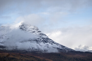 A beautiful autumn landscape with snowy mountain tops in Northern Norway. Seasonal scenery of Scandinavia.
