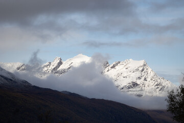 A beautiful autumn landscape with snowy mountain tops in Northern Norway. Seasonal scenery of Scandinavia.