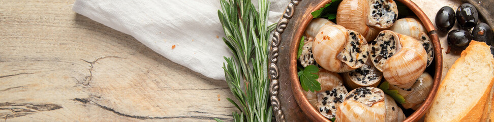 Bourgogne Escargot Snails with garlic oil in a metal plate.