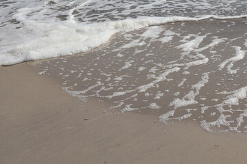 Ocean Wave Foam Patterns on Sandy Beach