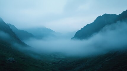 Misty fog creeping over a quiet mountain valley at dawn, creating a peaceful and ethereal landscape filled with dreamlike beauty