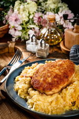 Minced meat cutlet with boiled sauerkraut.