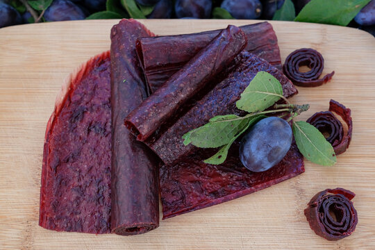 Fruit leather and rolls. Homemade or handmade pastille on the wooden board.