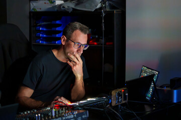Video Director Managing Multiple Screens and Equipment in a Control Room During a Live Broadcast