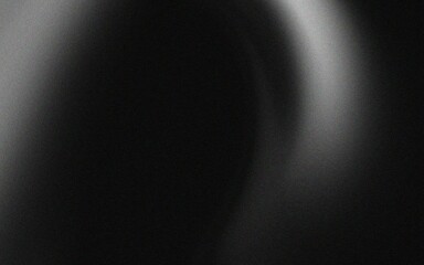 Abstract black and white background with a blurred light source creating a halo effect.