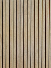 Background of oak acoustic wood wall panel. Vertical light brown natural wood textured wall. Vertical line wood panel texture pattern for decoration.