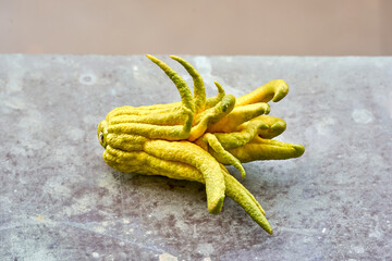Buddha's hand lemon on a rustic background