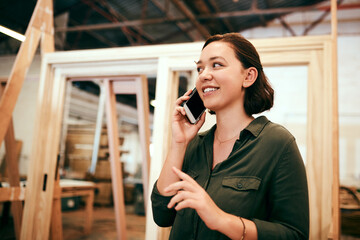 Idea, phone call and smile of carpenter woman in workshop for professional joinery or woodworking....