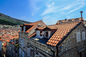 Charming rooftops of historic Dubrovnik under a clear blue sky during late afternoon
