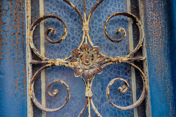 Detailed vintage ironwork on a weathered blue wall in Dubrovnik Croatia capturing the charm of the old town architecture