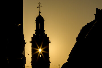 Sun on Santa Catalina church silhouette Valencia, Spain 
