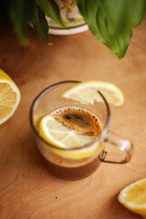 Espresso Romano, coffee with a slice of lemon, on a wooden table