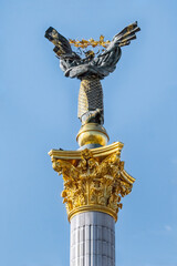 Kyiv, Ukraine - October 27, 2023: Detailed close-up of the top rear view of the Independence Monument in Kyiv showcasing its golden decorations on a clear blue sky. Monument symbolizes Ukraine freedom