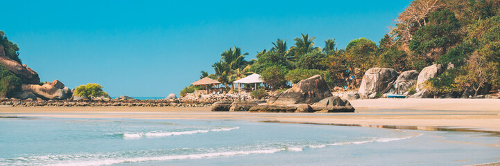 Canacona, Goa, India. Sunny Sky Over Calm Water Of Arabian Sea. Natural Landscape With Sandy Palolem Beach At Sunny Summer Day With Blue Sky