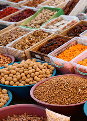 Colorful array of spices nuts and dried fruits at a bustling market in Turkey