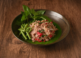 Laab Thaifood menu, raw food. laab moo mee of the North Lanna Thai food style, on table background. thaifood concept. Lanna Thai food.