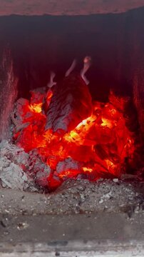 Vertical video of fire flames in fireplace. Cosy and calm burning logs