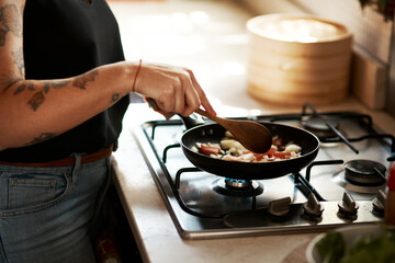 Hands, woman and cooking with frying pan in kitchen on stove with food and vegetables. Closeup,...