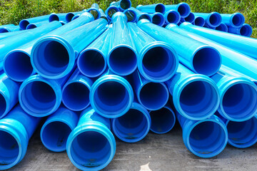 Stack of large blue water pipes, PVC nylon water pipes unpacked used on the construction site for...