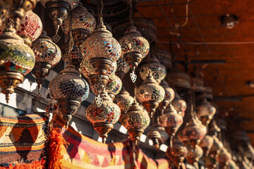 Colorful mosaic lanterns hanging in a Cappadocia market during the late afternoon light